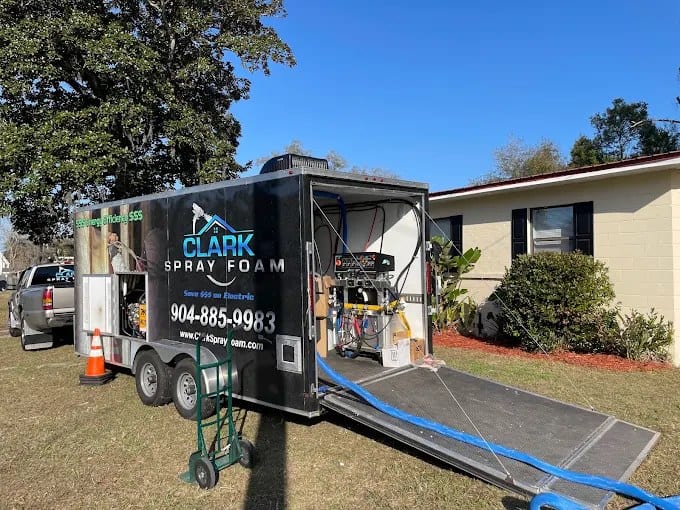 Clark Spray Foam spray rig trailer parked at a home
