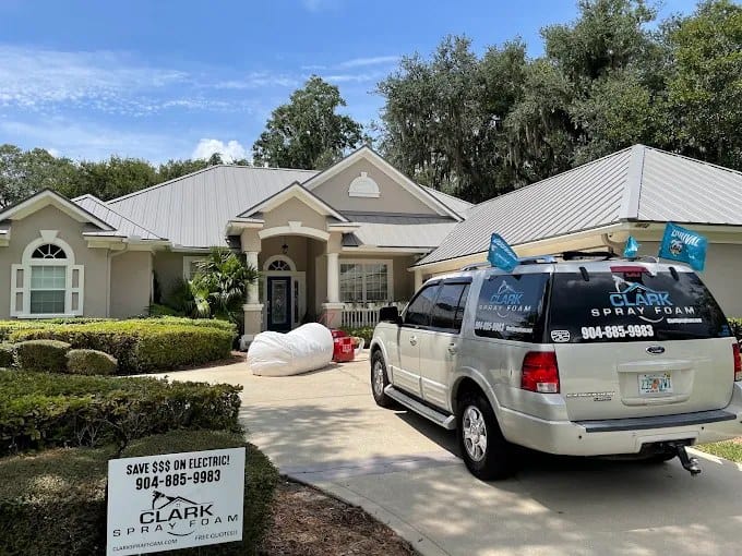 Clark Spray Foam vehicle and yard sign at a residential insulation job